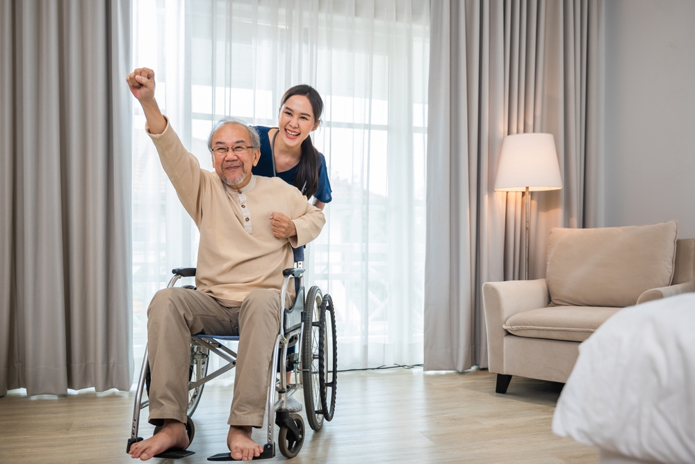 Support worker assisting a wheelchair user outdoors